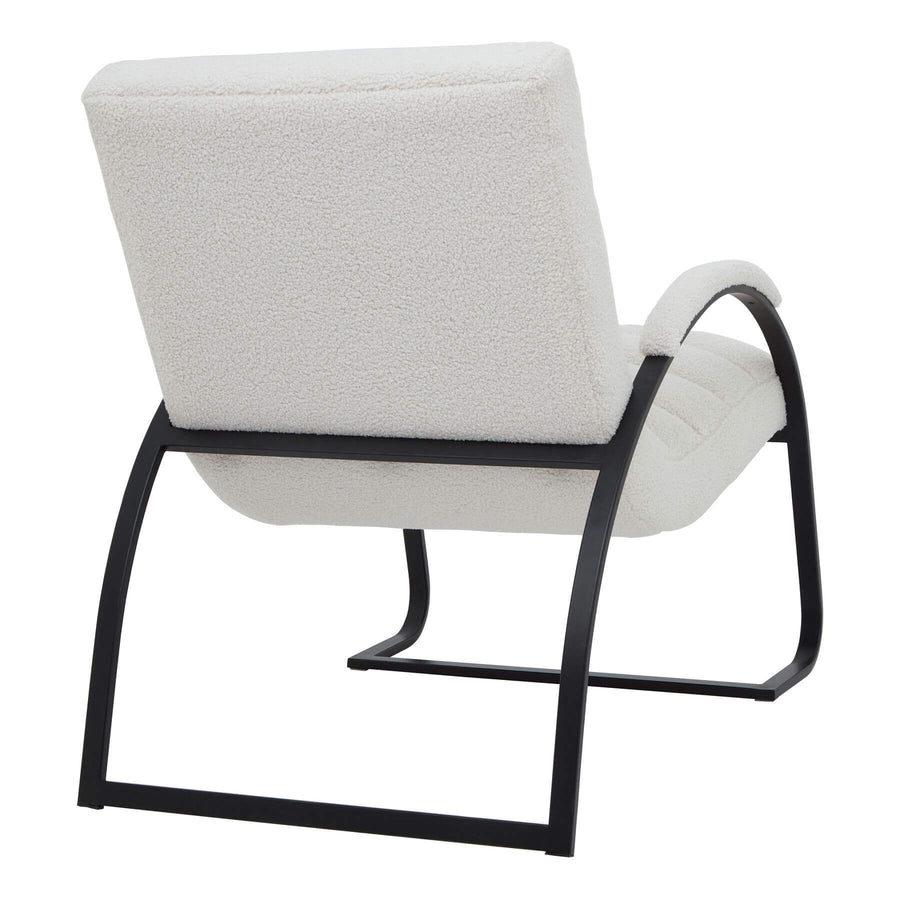 Cream boucle ribbed ark chair with curved black metal frame, channeled upholstery, and rocking motion for modern interiors by Sostter at brixbailey.com