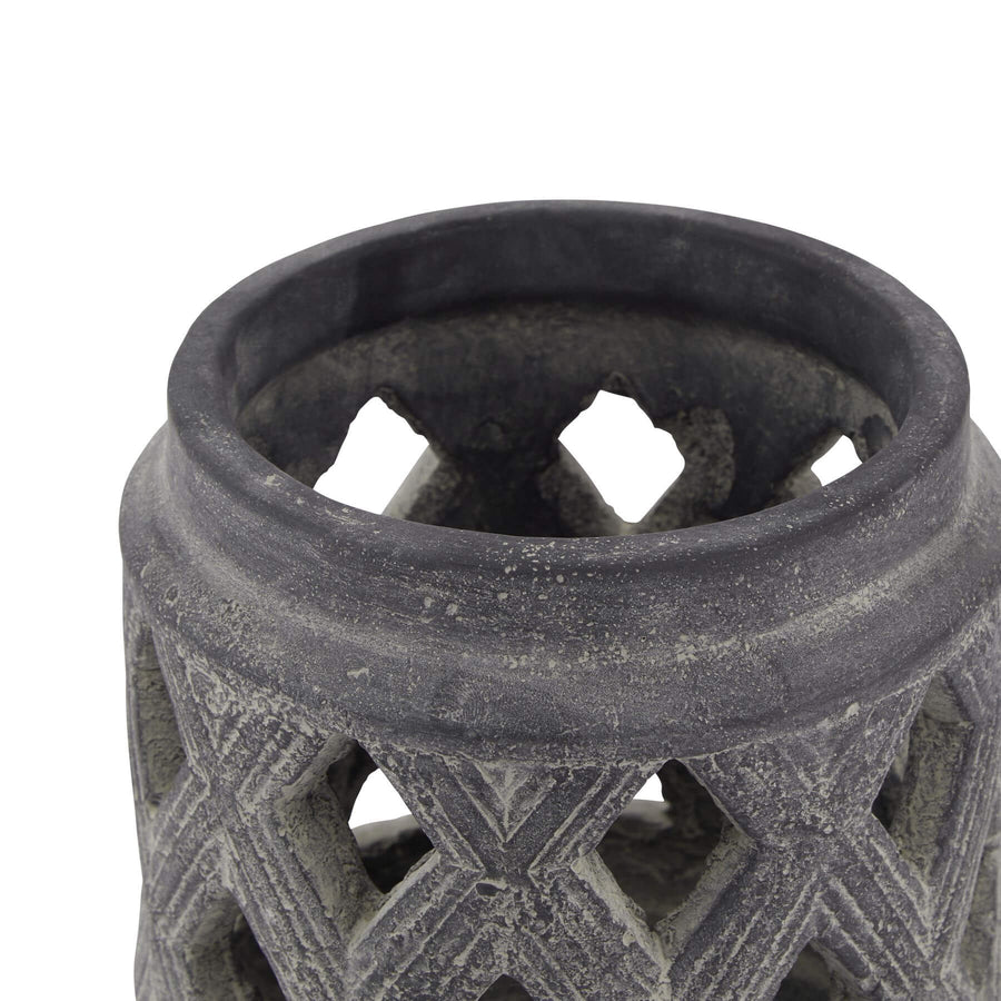 Grey ceramic lattice lantern with geometric Mediterranean patterns, casting intricate shadow art when lit. by Sostter at brixbailey.com