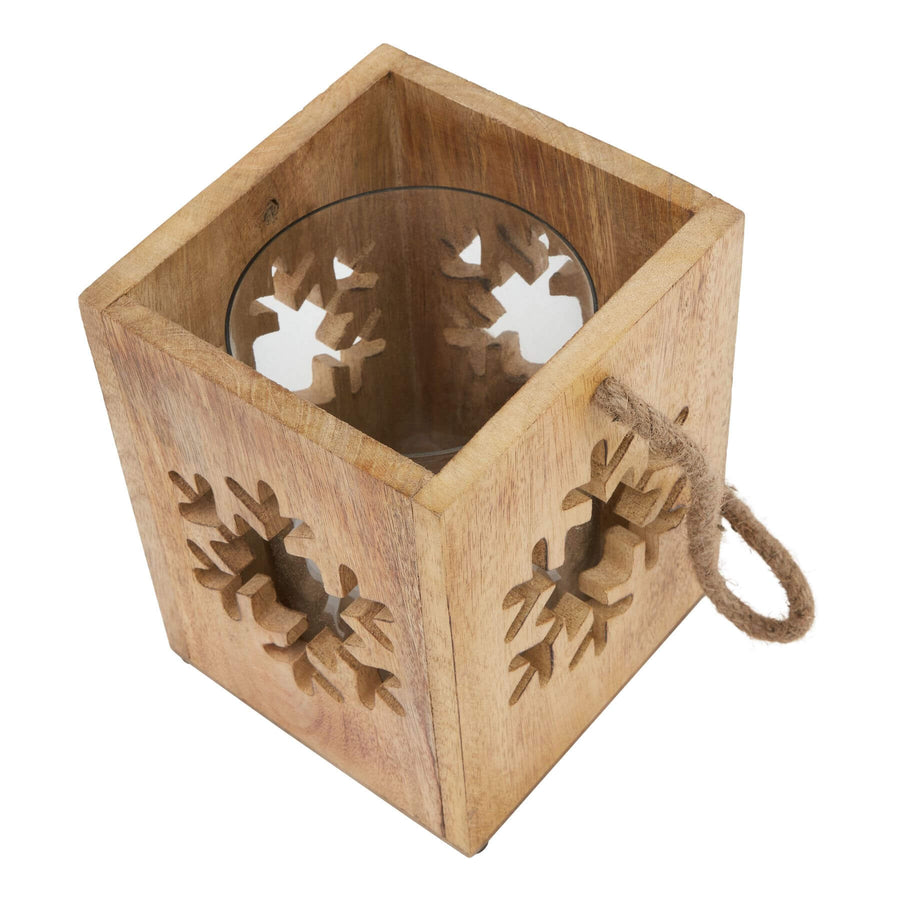 Handcrafted wooden snowflake tealight holder with intricate design, natural wood grain, and warm brown tones for cozy winter decor. by Sostter at brixbailey.com