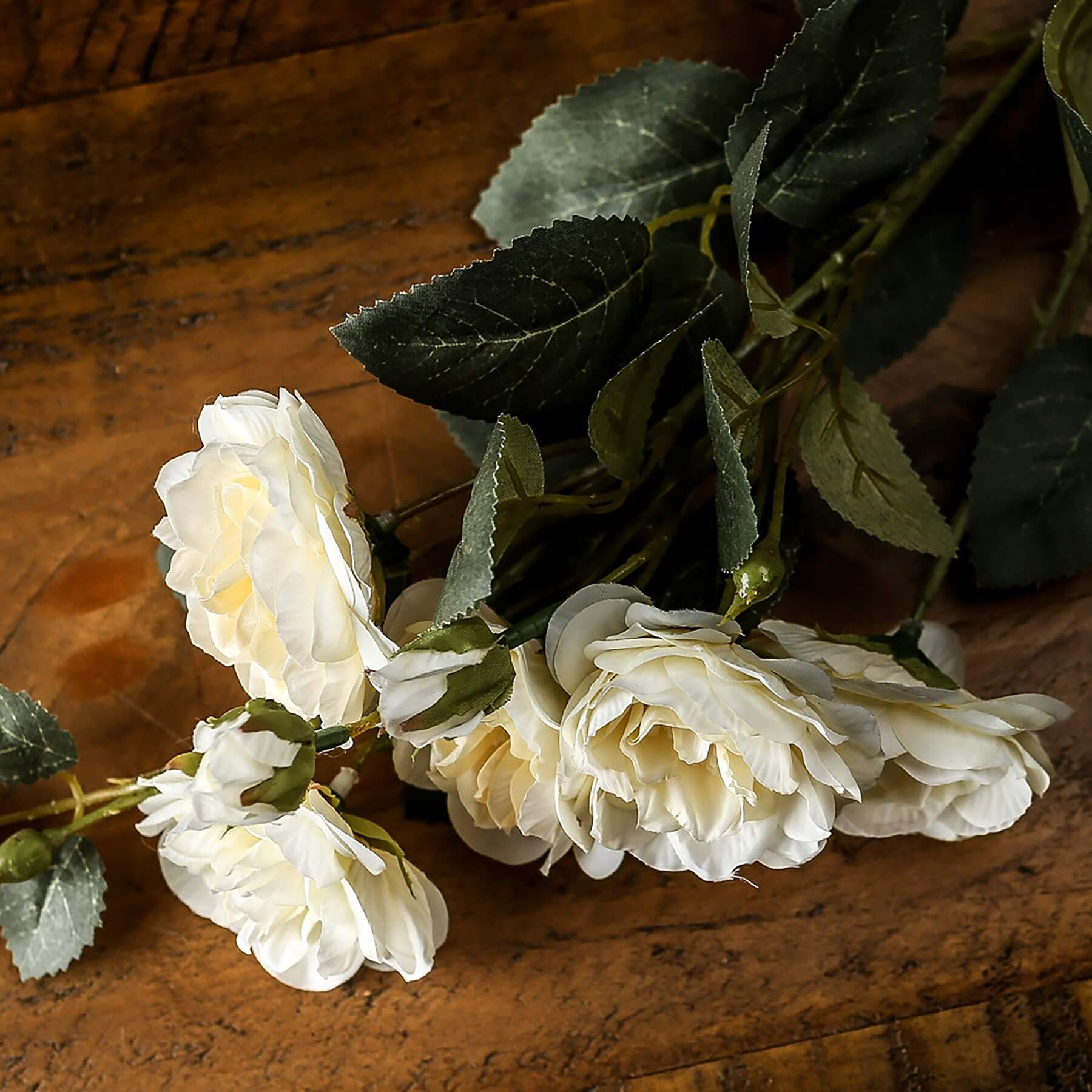 Soft white cottage rose stem with lifelike ivory blooms and green foliage for elegant home decor by Sostter at brixbailey.com