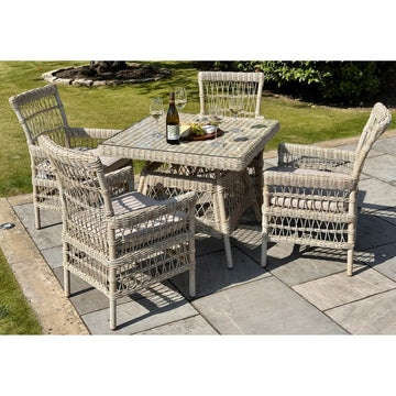 Provence 4-seater outdoor dining set in beige HDPE rattan with tempered glass table and Olefin cushions by Sostter at brixbailey.com
