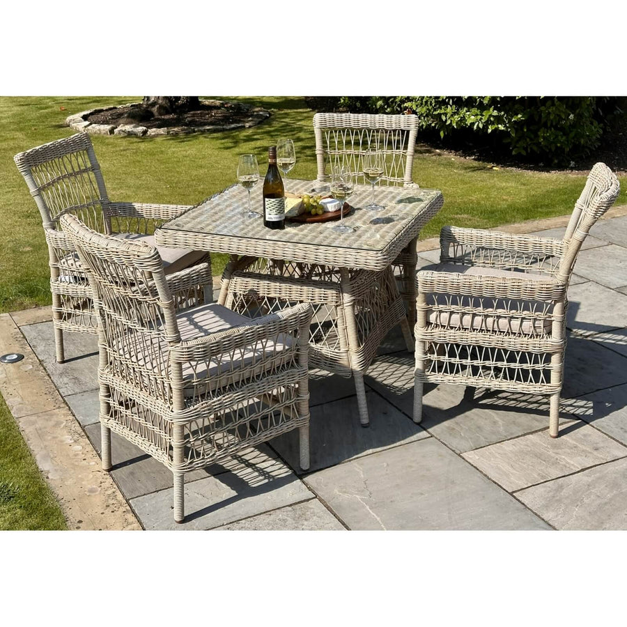 Provence 4-seater outdoor dining set in beige HDPE rattan with tempered glass table and Olefin cushions by Sostter at brixbailey.com