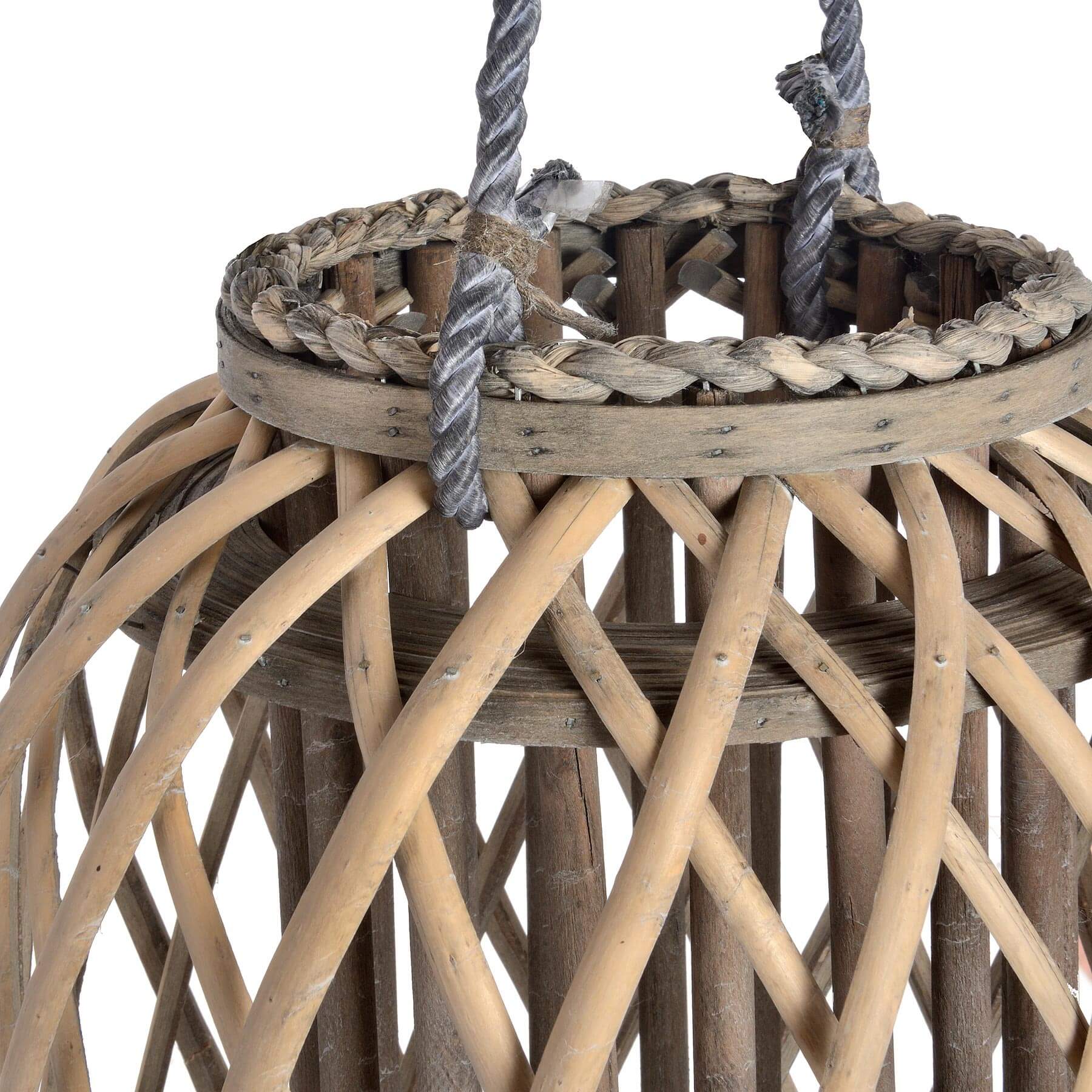Handwoven rattan lantern in rich brown, casting warm light patterns for indoor or outdoor ambiance. by Sostter at brixbailey.com