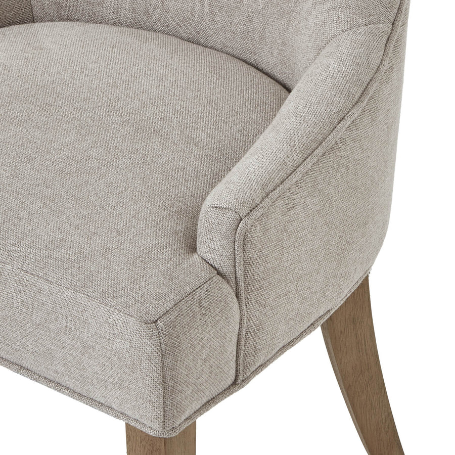Oatmeal twill dining chair with tufted detailing, curved back, and solid oak legs for elegant comfort by Sostter at brixbailey.com