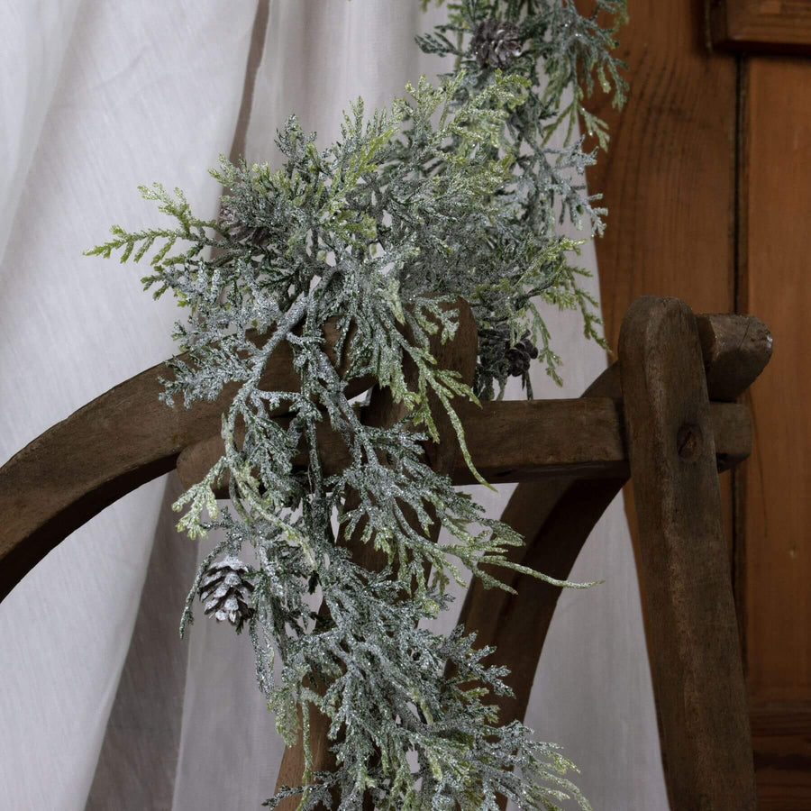 Frosted pine garland with lifelike needles and pinecones, white with sparkling frost accents, 180cm winter decor by Sostter at brixbailey.com