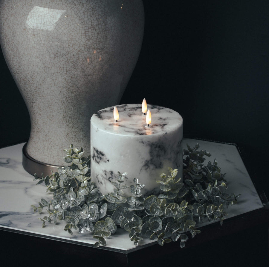 Frosted eucalyptus candle wreath with silver accents, sage green foliage, and realistic winter detailing for seasonal decor. by Sostter at brixbailey.com