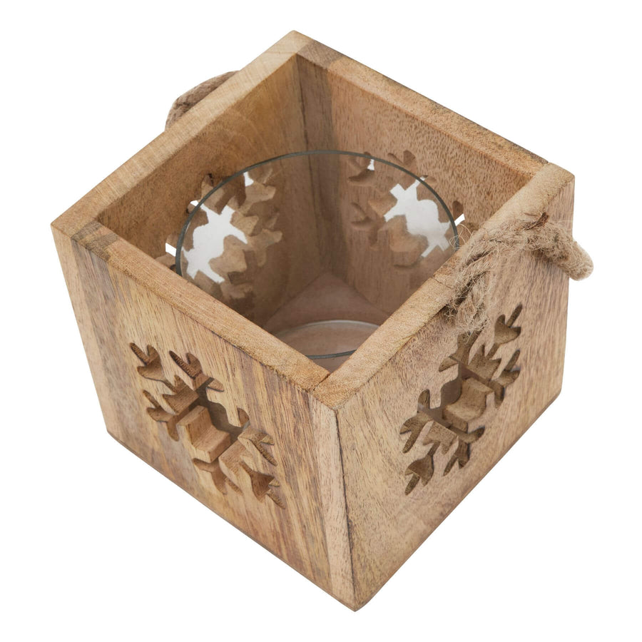 Handcrafted wooden snowflake tealight holder with glass insert, warm brown rustic decor for winter ambiance. by Sostter at brixbailey.com