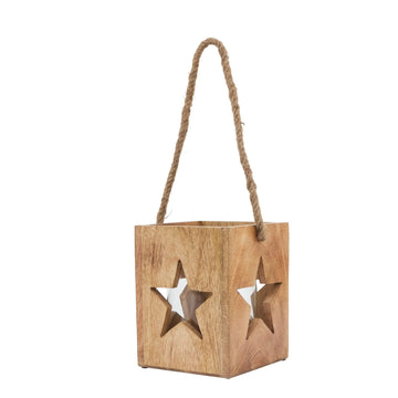 Handcrafted wooden star tealight holder with intricate celestial design, casting warm boho shadows on natural wood. by Sostter at brixbailey.com