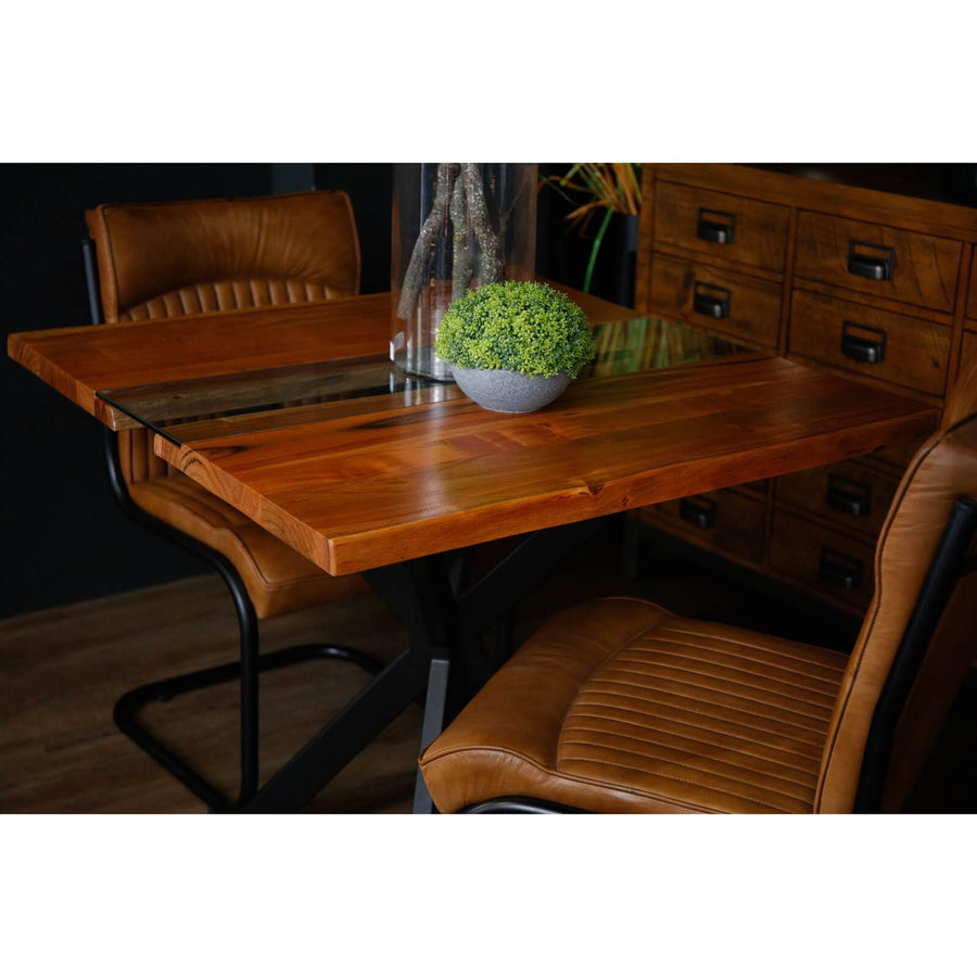Live edge square dining table with glass river center, natural wood grain, black metal base, and tempered glass insert. by Sostter at brixbailey.com