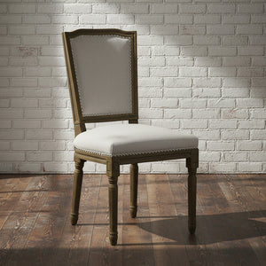 Grey dining chair with handcarved rubberwood frame and neutral woven upholstery, ergonomic design by sostter at brixbailey.com