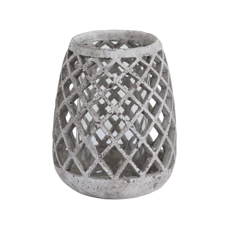 Large conical ceramic lattice hurricane lantern in natural stone, emitting soft light patterns through decorative cutouts. by Sostter at brixbailey.com