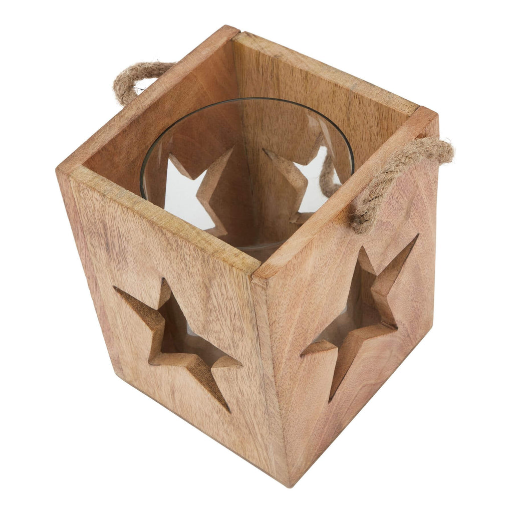 Handcrafted wooden star tealight holder with celestial design, casting warm boho shadows for home decor. by Sostter at brixbailey.com