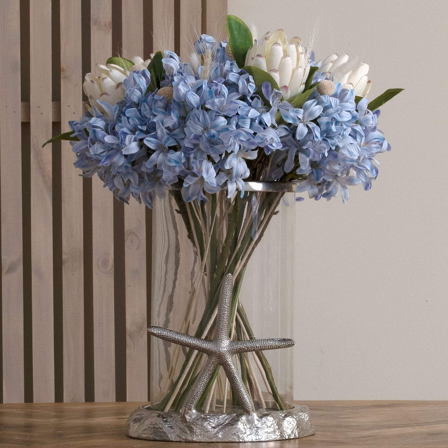 Faux white protea stem with hyper-realistic closed buds, 67 cm tall, for elegant floral arrangements and home decor. by Sostter at brixbailey.com