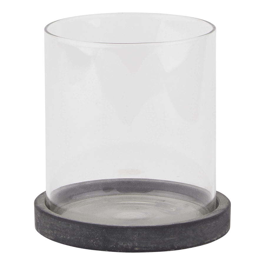 Grey ceramic hurricane lantern with glass panels, Mediterranean coastal style, casting ambient light patterns for indoor or outdoor decor. by Sostter at brixbailey.com