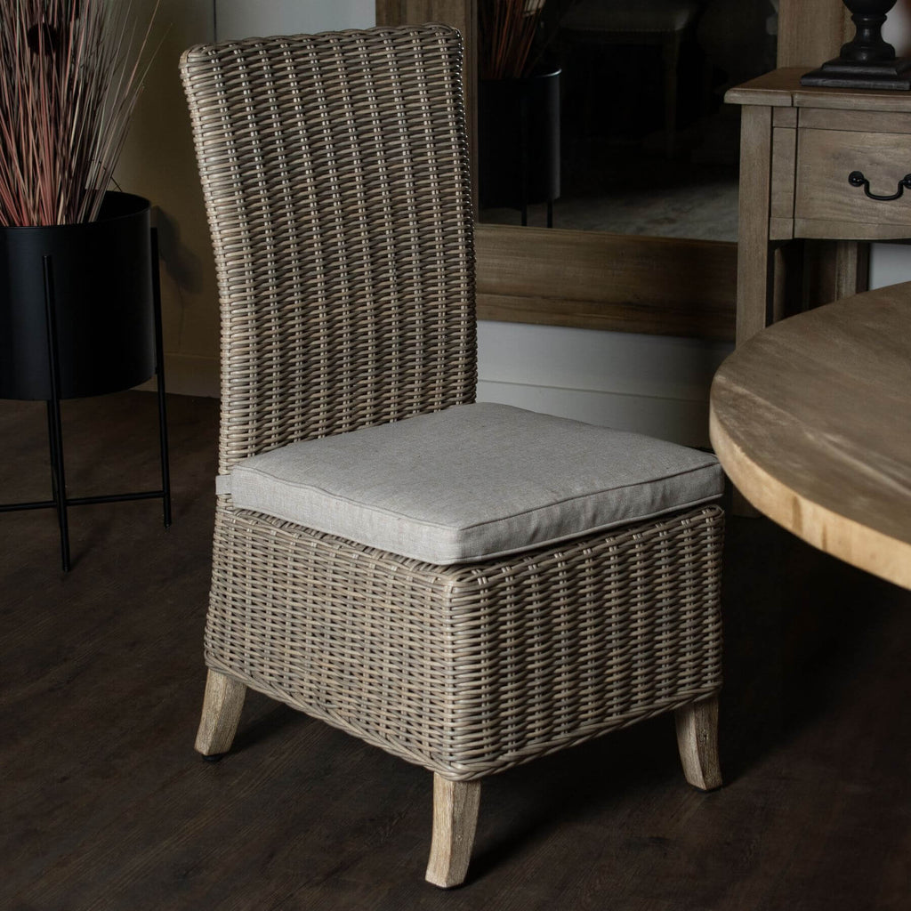 Beige Capri outdoor dining chair with HDPE wicker, powder-coated aluminum frame, and acacia wood feet, includes Olefin cushion. by Sostter at brixbailey.com