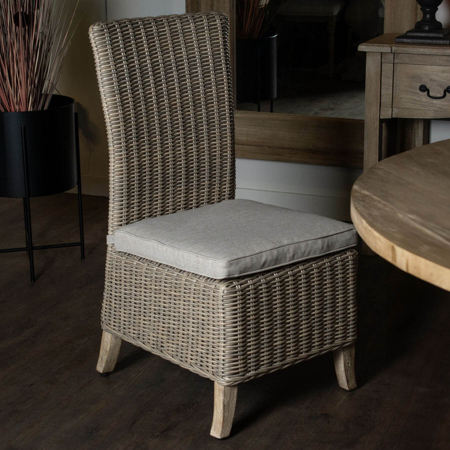 Beige Capri outdoor dining chair with HDPE wicker, powder-coated aluminum frame, and acacia wood feet, includes Olefin cushion. by Sostter at brixbailey.com