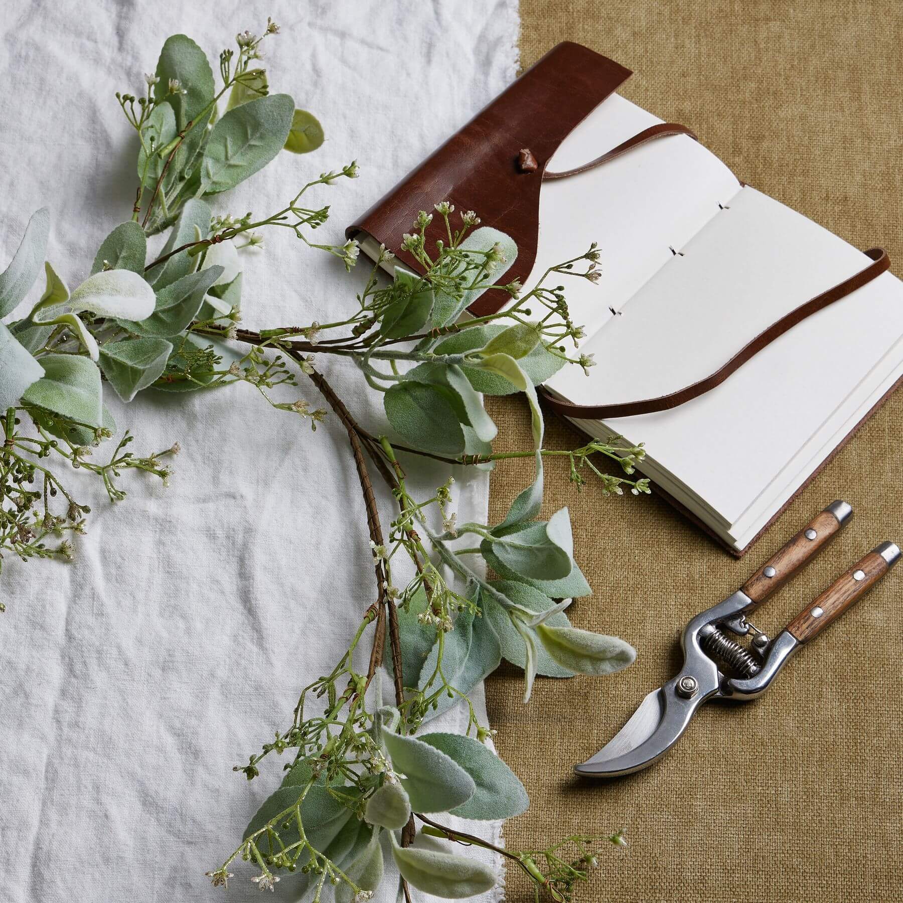 Elegant winter garland with lamb's ear foliage and wax flowers in soft grey and green tones, 153cm long by Sostter at brixbailey.com