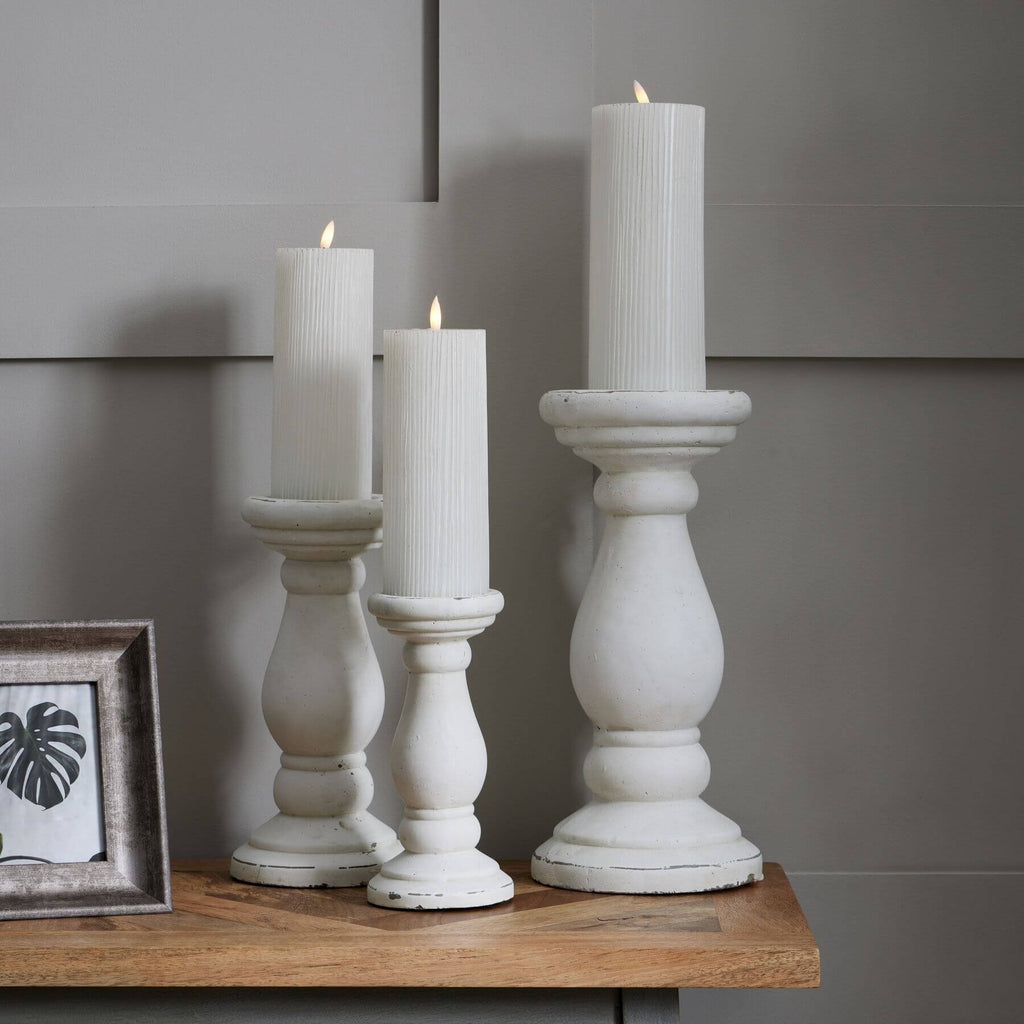 Handcrafted white ceramic candle holder with minimalist design and matte finish for modern decor. by RoomLondon at brixbailey.com