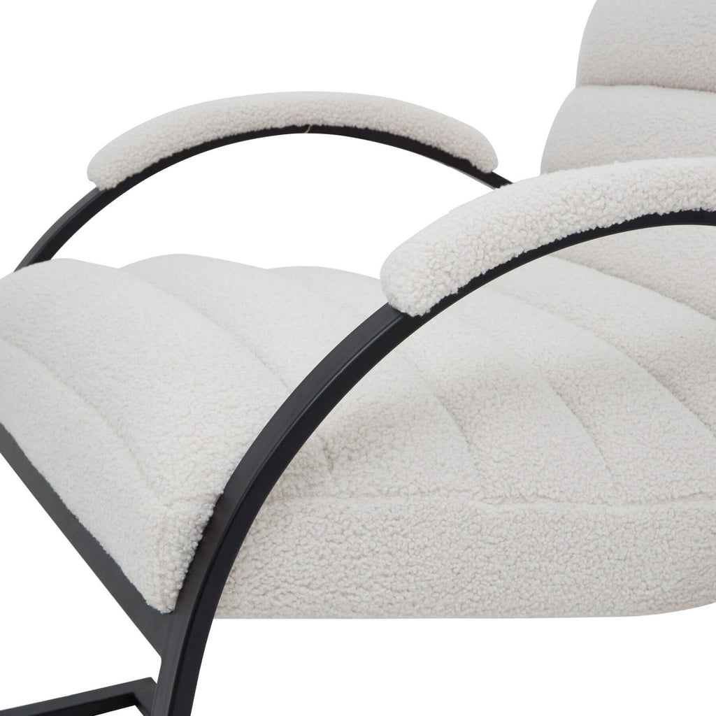 Cream boucle ribbed ark chair with curved black metal frame, modern sculptural accent piece for living spaces by Sostter at brixbailey.com