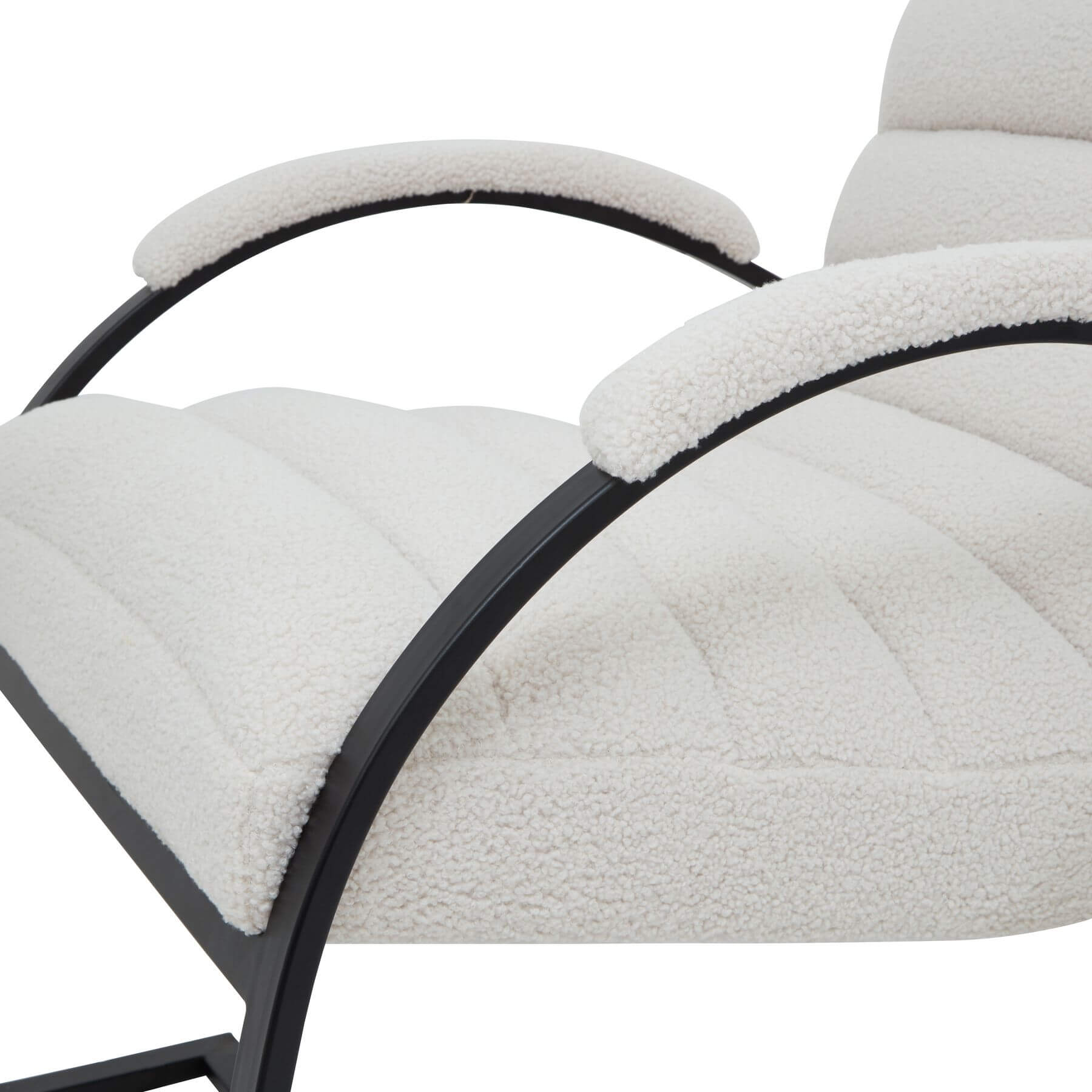 Cream boucle ribbed ark chair with curved black metal frame, modern sculptural accent piece for living spaces by Sostter at brixbailey.com