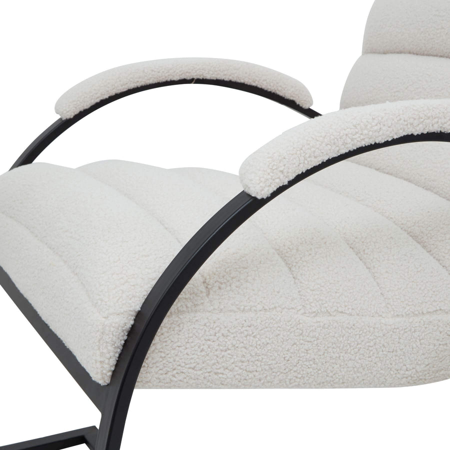 Cream boucle ribbed ark chair with curved black metal frame, modern sculptural accent piece for living spaces by Sostter at brixbailey.com