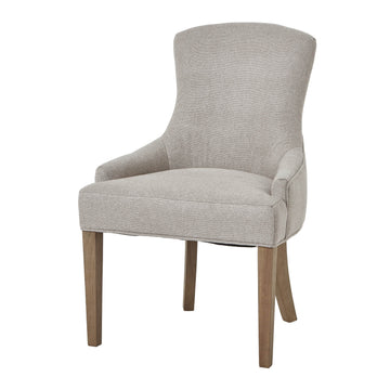 Oatmeal twill dining chair with tufted detailing, curved back, and solid oak legs for elegant comfort. by Sostter at brixbailey.com