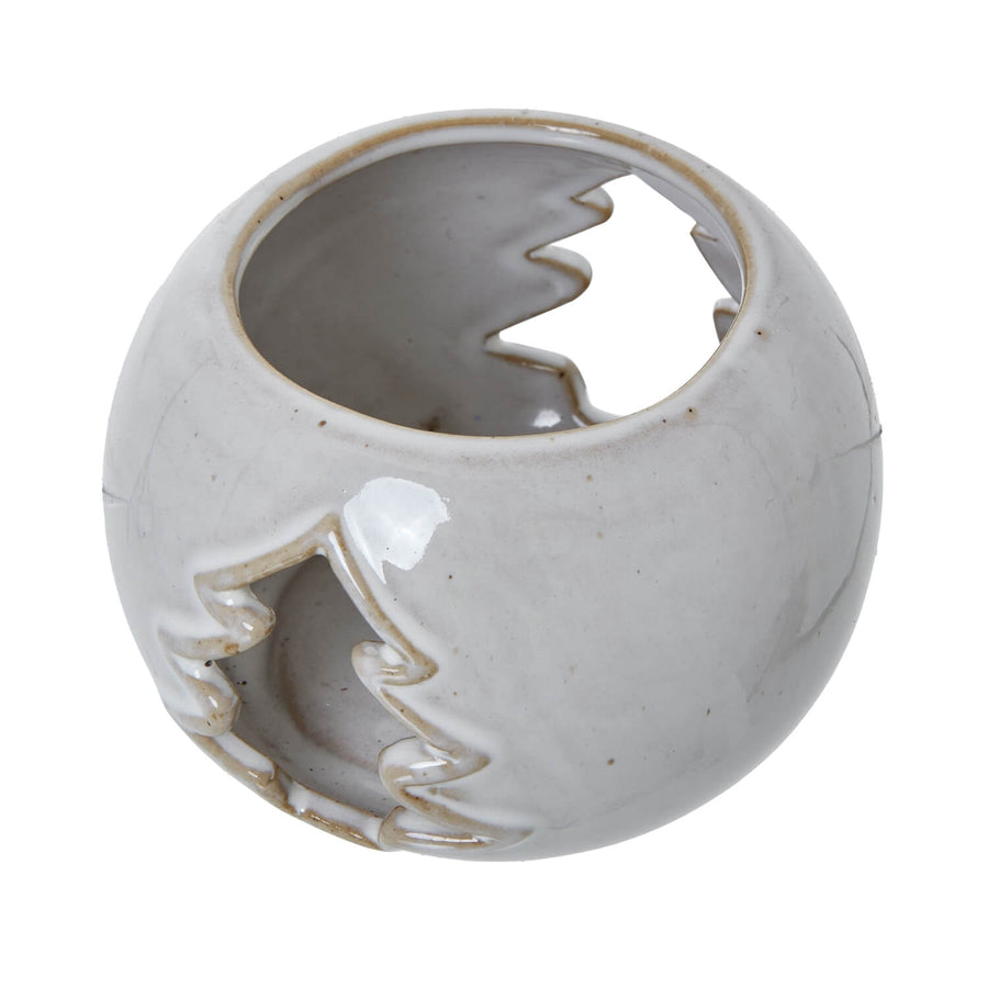 White ceramic tealight holder with tree cut-out pattern, casting dancing light shadows for cozy home decor ambiance by Sostter at brixbailey.com