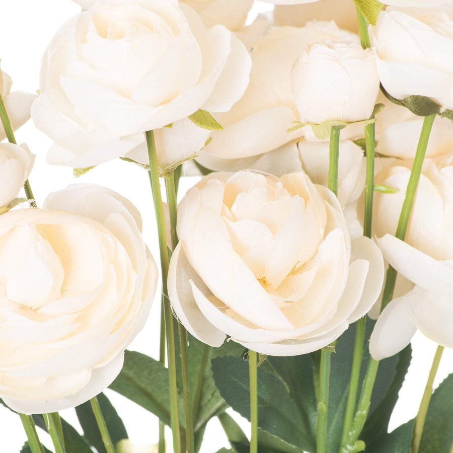 Creamy white faux ranunculus flower with green leaves, lifelike artificial bloom for home decor by Sostter at brixbailey.com