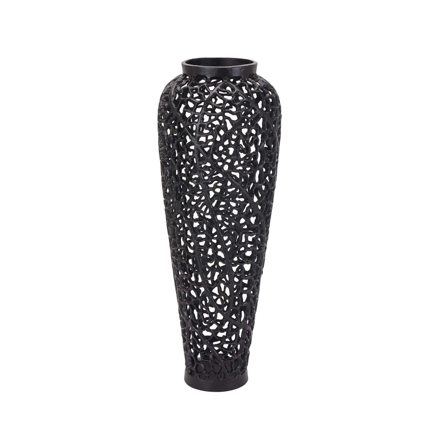 Matte black lattice vase with geometric cutouts, casting dynamic shadows, made of architectural-grade aluminum. by Sostter at brixbailey.com