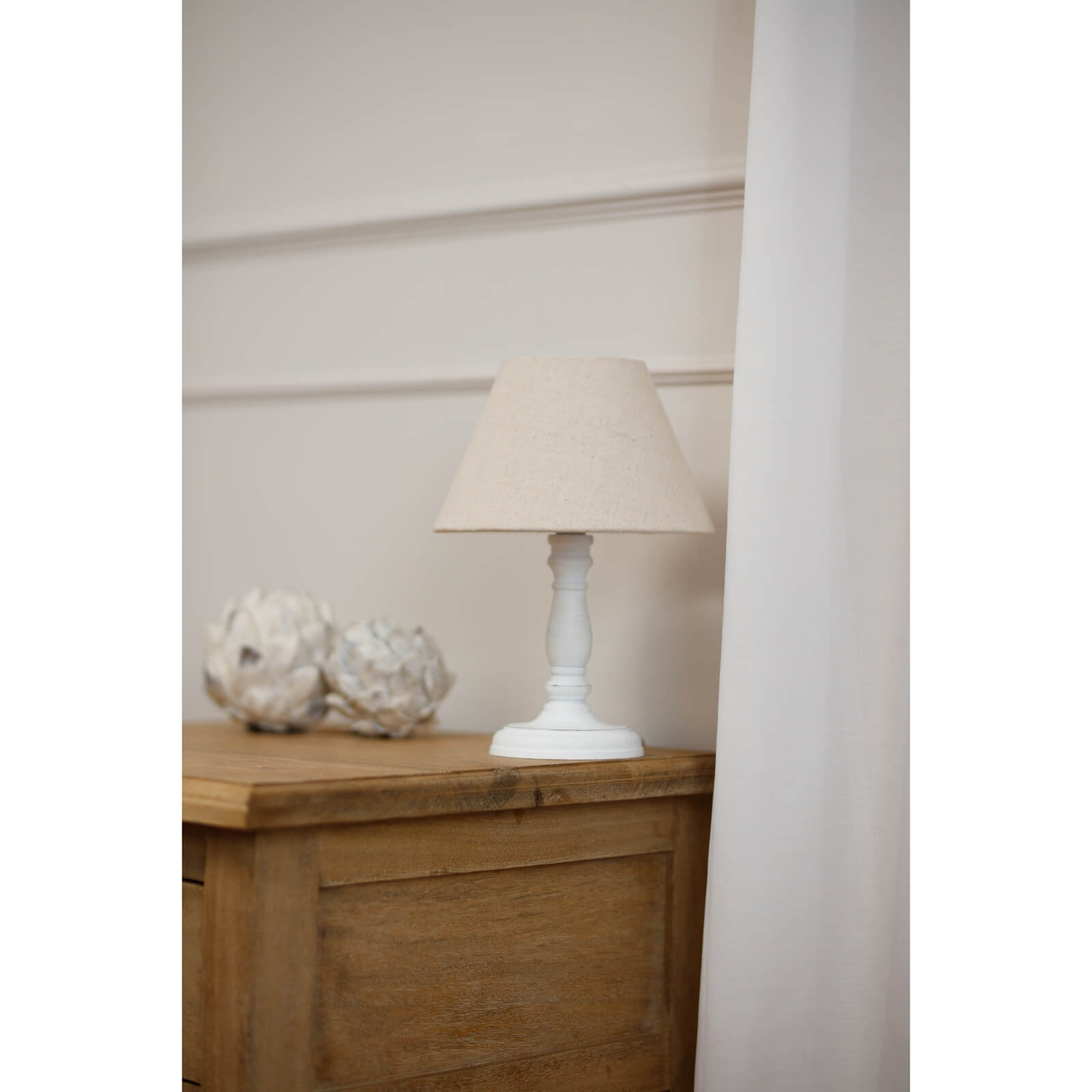 Cyrene table lamp with white wooden base and oatmeal shade, warm beige lighting for cozy home decor by Sostter at brixbailey.com