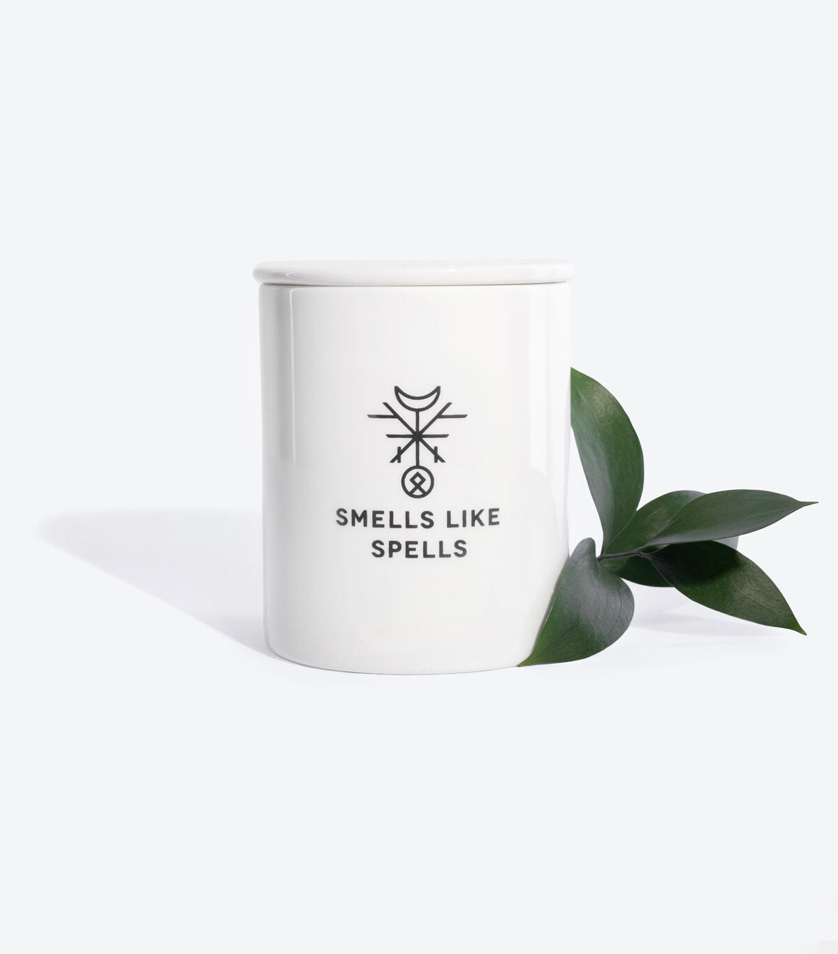 elegant handmade porcelain hermit candle glowing softly on a dark wood surface