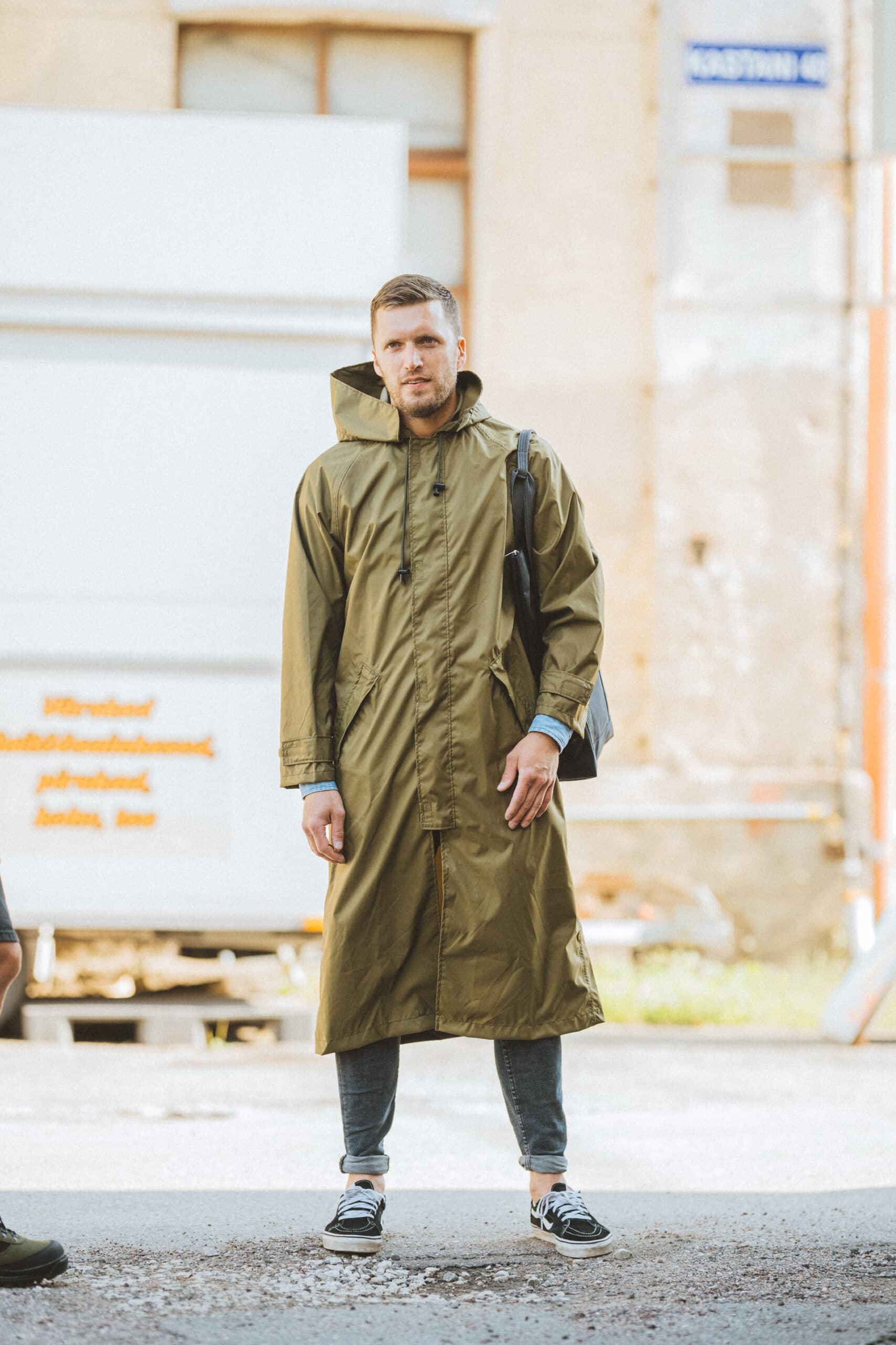 a soft green raincoat folded neatly in its pouch, ready for a peaceful adventure