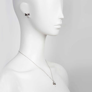softly lit dark dragonfly pendant on a silver chain, a comforting gift of strength