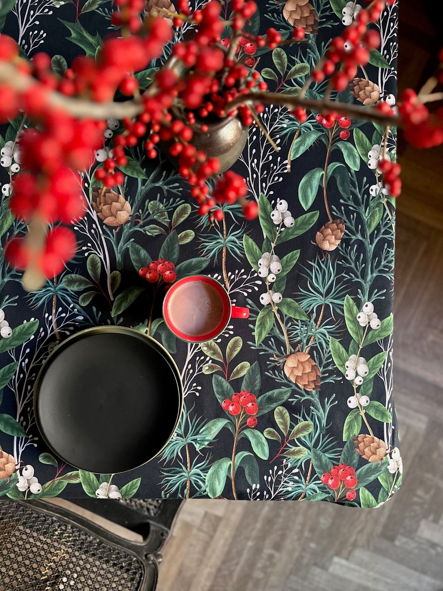 playful christmas forest tablecloth on a table set for a fun family cookie-decorating party