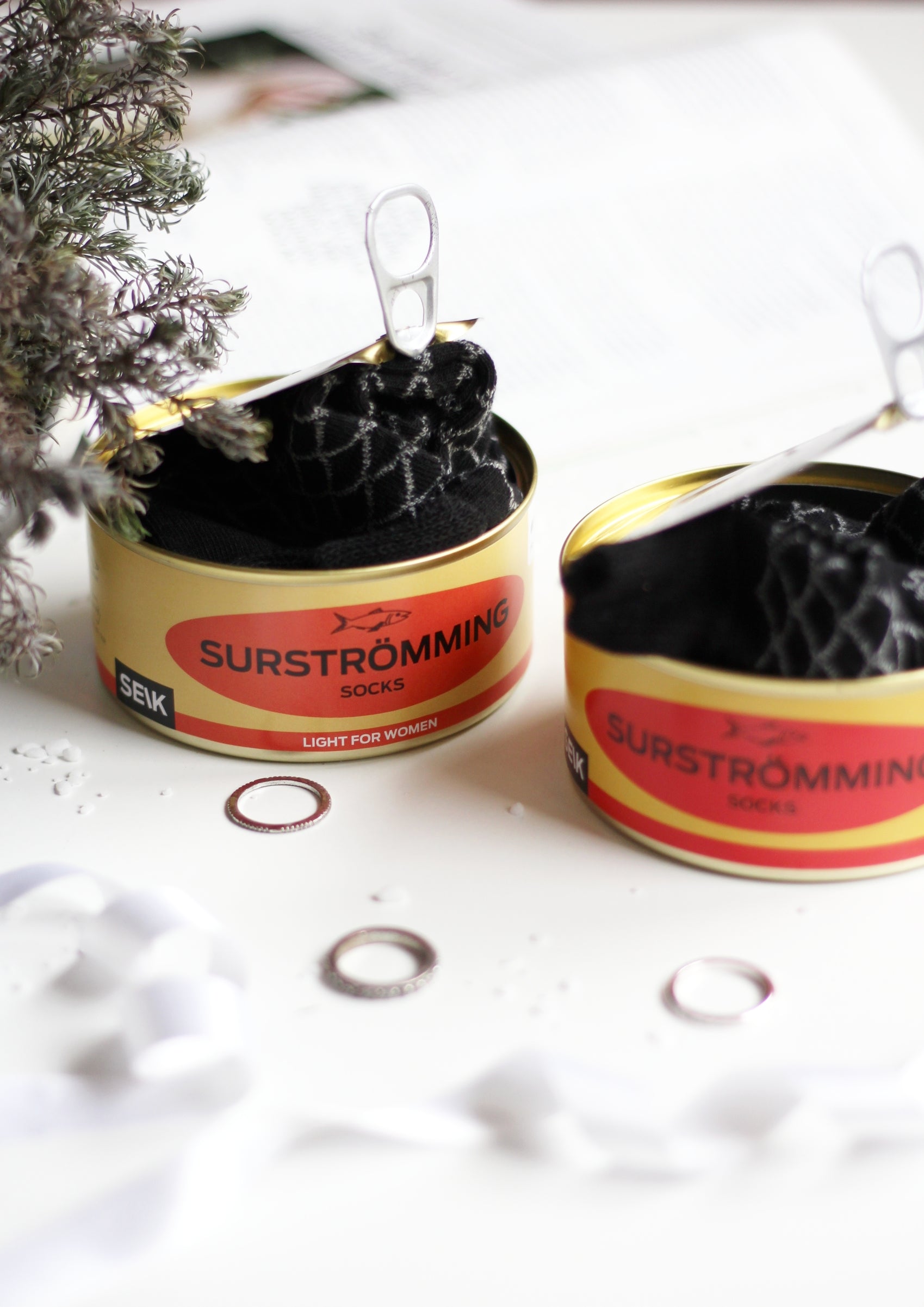 confident close-up of a stylish surströmming sock gift set in a tin can for men sizes 40-46