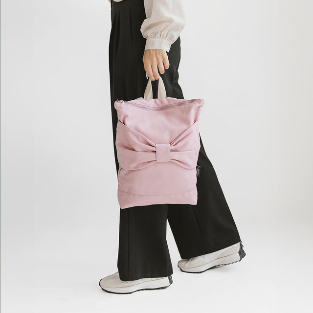 Chic Pink Bow Backpack – Playful & Versatile Style by Muni at brixbailey.com