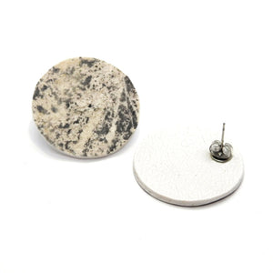 bold slate and marble orbit mere marmor earrings in dramatic studio lighting