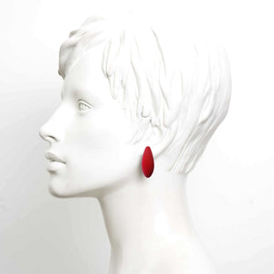 bold mini cherries earrings with cosmic dust finish on a dark background