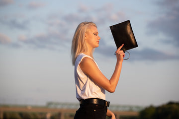 Sleek Black Leather Clutch with Metal Ring – Elegant & Modern by PYKOK at brixbailey.com