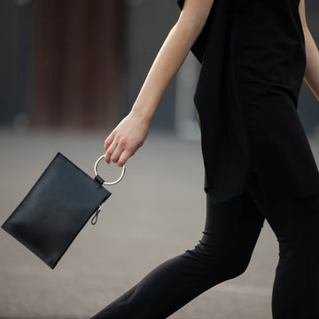 Sleek Black Leather Clutch with Metal Ring – Elegant & Modern by PYKOK at brixbailey.com