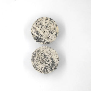 bold slate and marble orbit kohev lumi earrings in dramatic studio lighting
