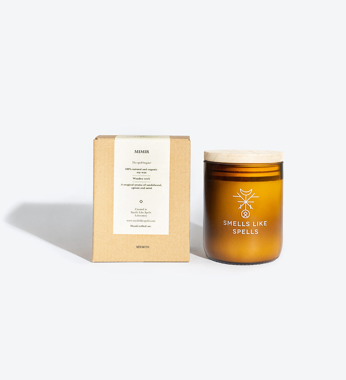 playful mimir candle with glowing wooden wick and amber glass jar on a bright desk