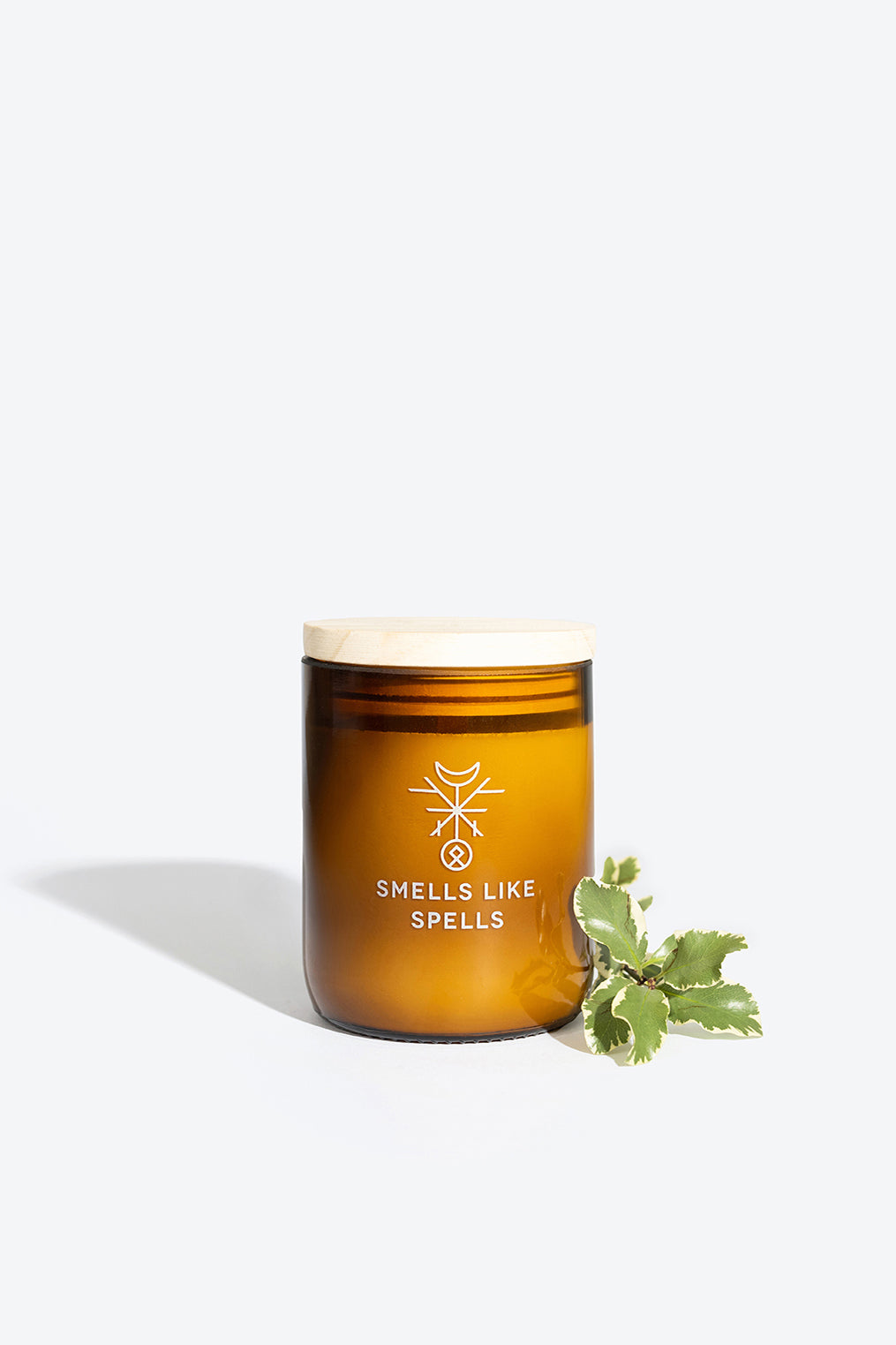 dellingr scented candle in amber glass glowing with a bold, confident aura