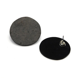 bold slate and marble orbit must süsi earrings in dramatic close-up, showcasing natural texture