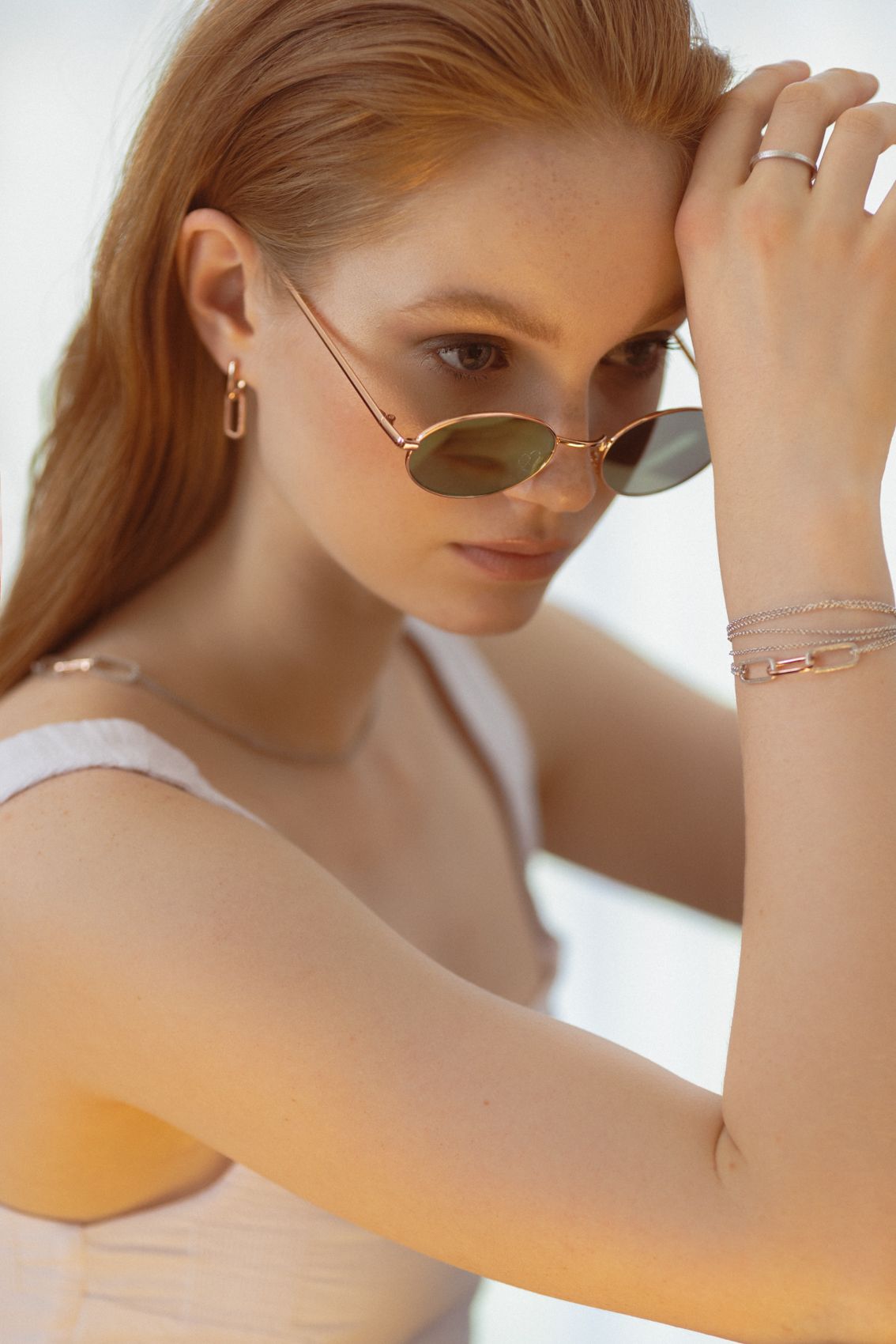 soft rose gold metropolitan earrings glowing in warm light, elegant and timeless estonian design
