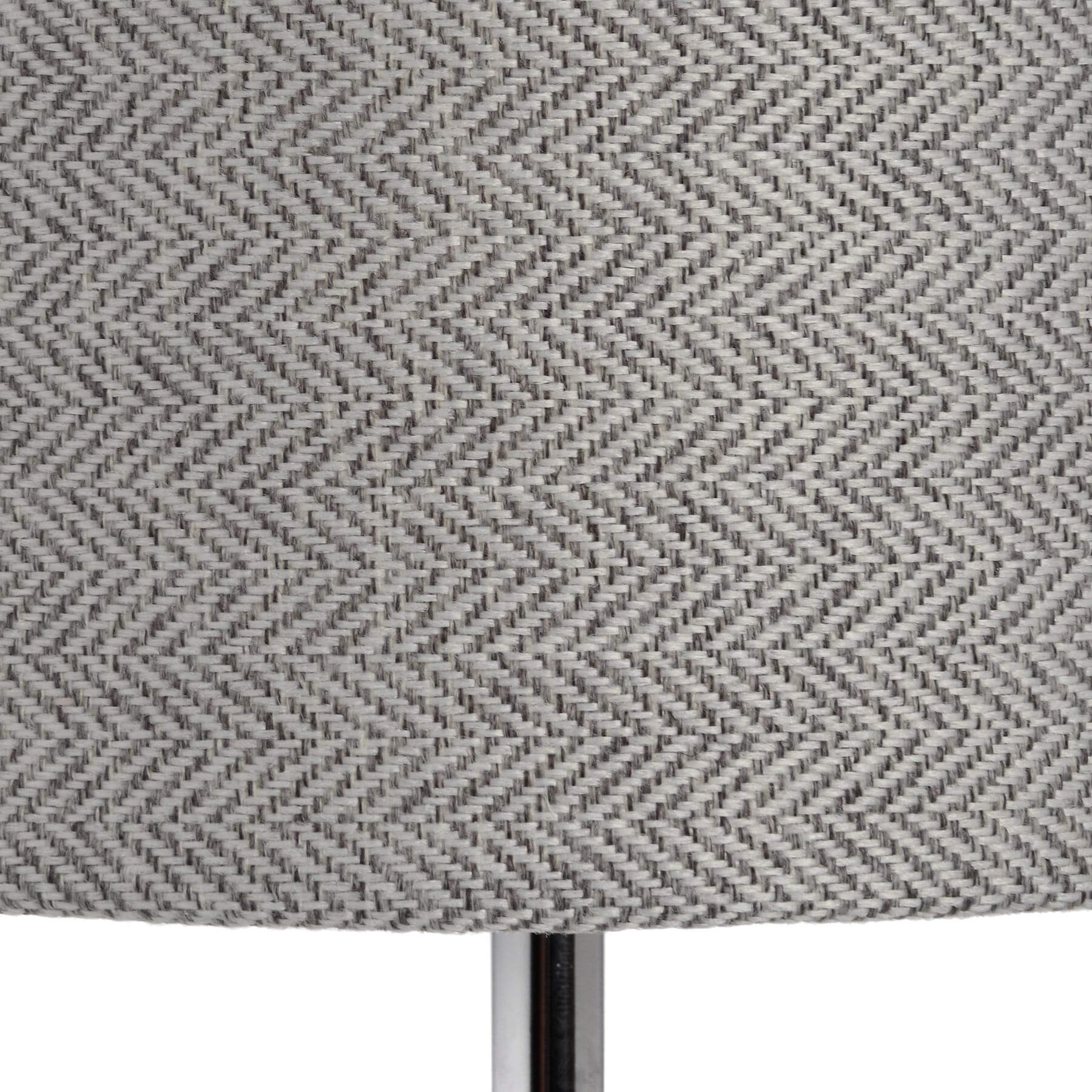 Silver designer table lamp with chrome base, glass accents, and herringbone fabric shade for warm ambient lighting by Sostter at brixbailey.com