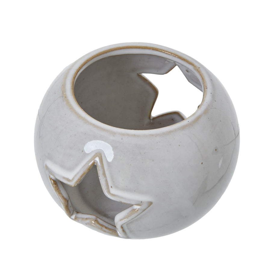 White ceramic tealight holder with star cutouts, projects constellations when lit, minimalist home decor by Sostter at brixbailey.com