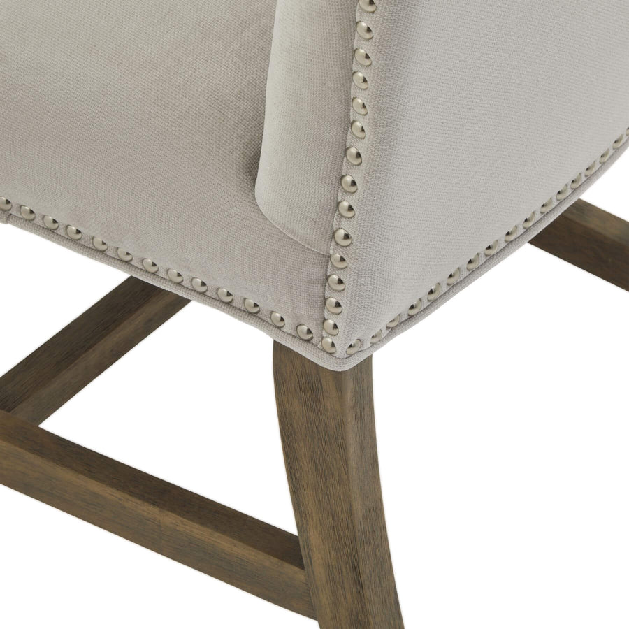 Cobham Grey Dining Chair with padded seat, grey upholstery, antique brass studs, and weathered oak frame by Sostter at brixbailey.com