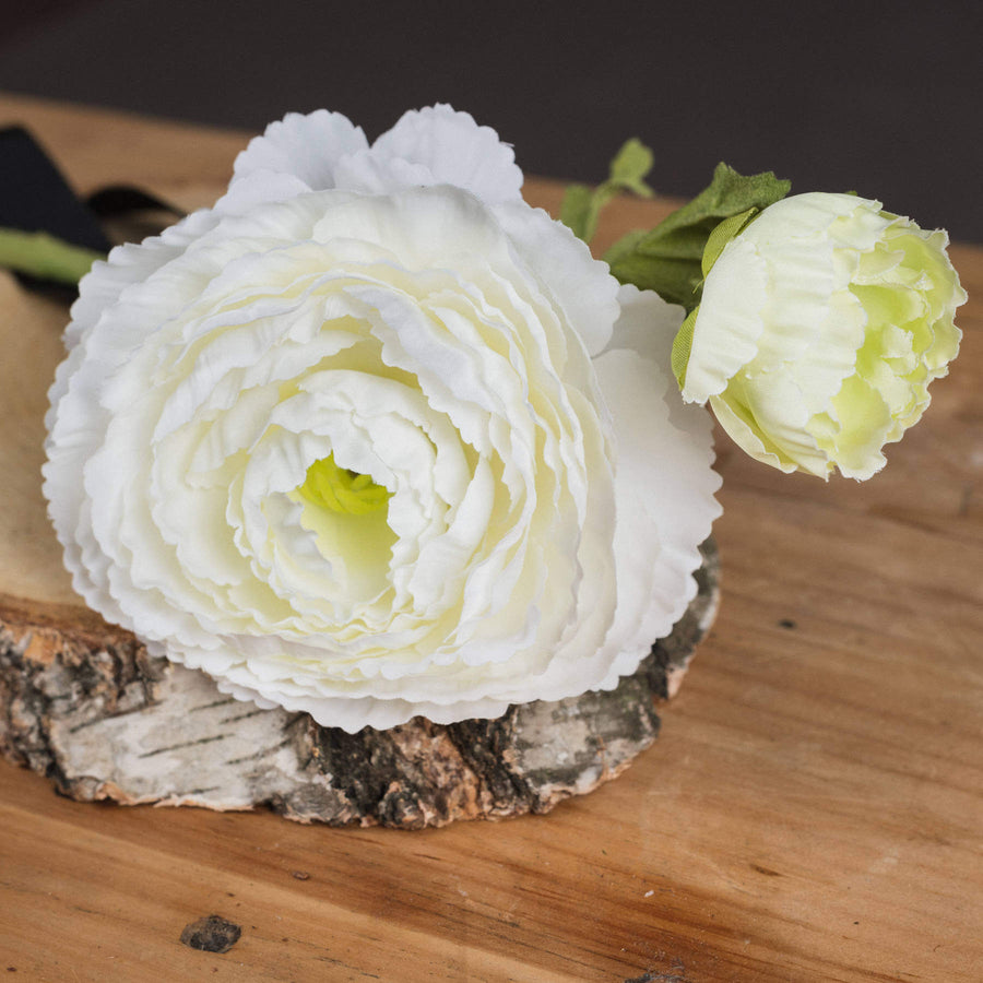 White artificial ranunculus spray with lifelike petals, 68cm long, perfect for home decor or floral arrangements. by Sostter at brixbailey.com