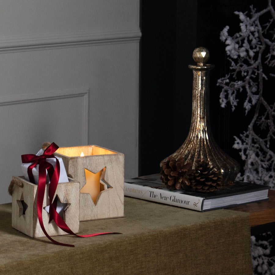 Handcrafted whitewashed wooden star tealight holder with natural grain, casting warm glow patterns for cozy decor. by Sostter at brixbailey.com
